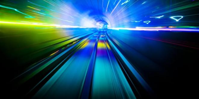 Blurred but bright image inside a train tunnel showing seemingly fast-moving lights 