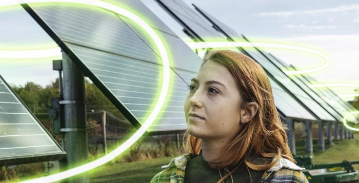 Young woman looking at solar panels